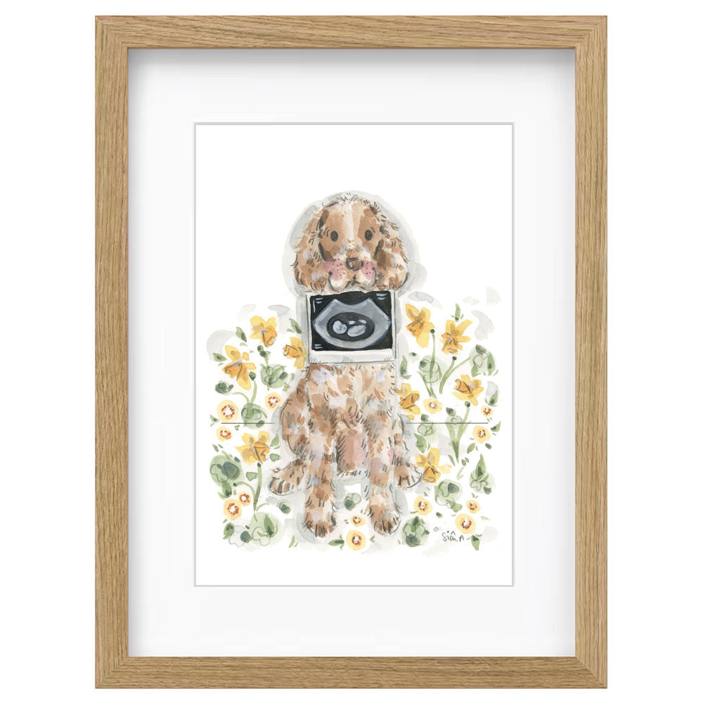 Framed watercolor art print featuring a brown and white dog wearing a black-and-white ultrasound screen, surrounded by yellow flowers, set in a light oak wood frame by UK Artist Sian Alexia Paine 