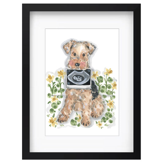 Framed watercolor art print of a small dog sitting among yellow flowers, holding an ultrasound scan in its paws, set in a black frame with a white mat by Sian Alexia Paine 